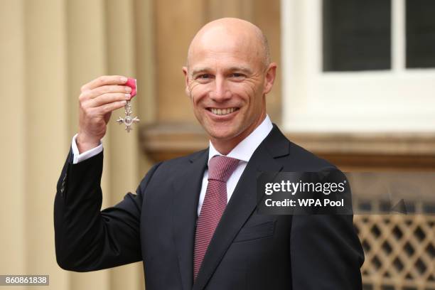 England and Great Britain hockey head coach Danny Kerry is made an MBE by Queen Elizabeth II during an Investiture ceremony at Buckingham Palace on...