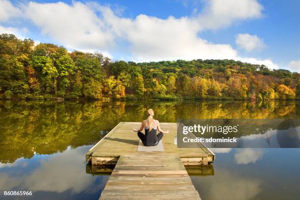 peaceful fall meditation - blonde yoga stock pictures, royalty-free photos & images