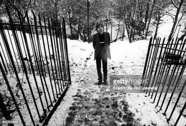 Singer and lyricist Mark E. Smith, of English rock group The Fall, at the gateway to a snowy park, 16th January 1981.