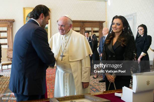 Pope Francis exchanges gifts with Lebanon Prime Minister Saad Hariri and his wife Lara Bashir El Alzem during a private audience at the Apostolic...