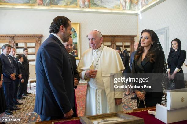 Pope Francis exchanges gifts with Lebanon Prime Minister Saad Hariri and his wife Lara Bashir El Alzem during a private audience at the Apostolic...