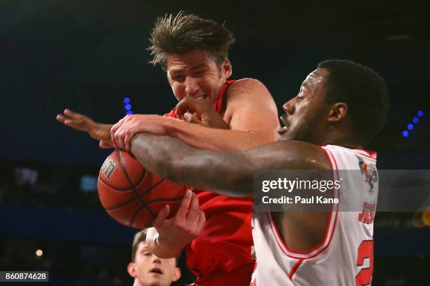 Damian Martin of the Wildcats pulls down a rebound against Delvon Johnson of the Hawks during the round two NBL match between the Perth Wildcats and...