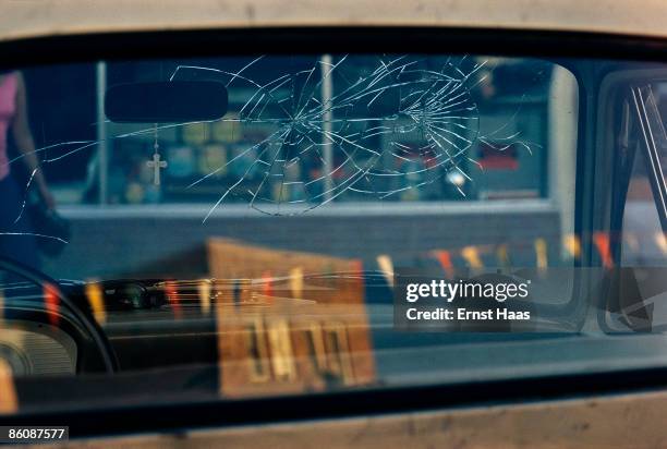 Cracks in the rear windscreen of a car, circa 1970.