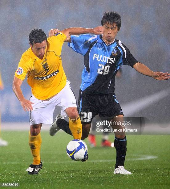 Hiroyuki Taniguchi of Kawasaki Frontale and John Hutchinson of Central Coast Mariners compete for the ball during AFC Champions League Group H match...