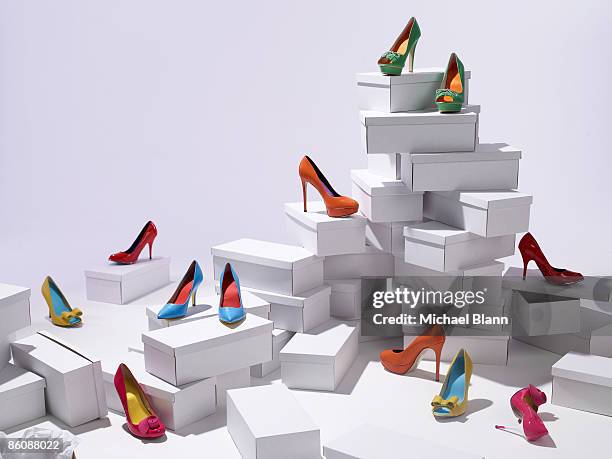 various shoes piled on shoe boxes - fashion shopping stockfoto's en -beelden