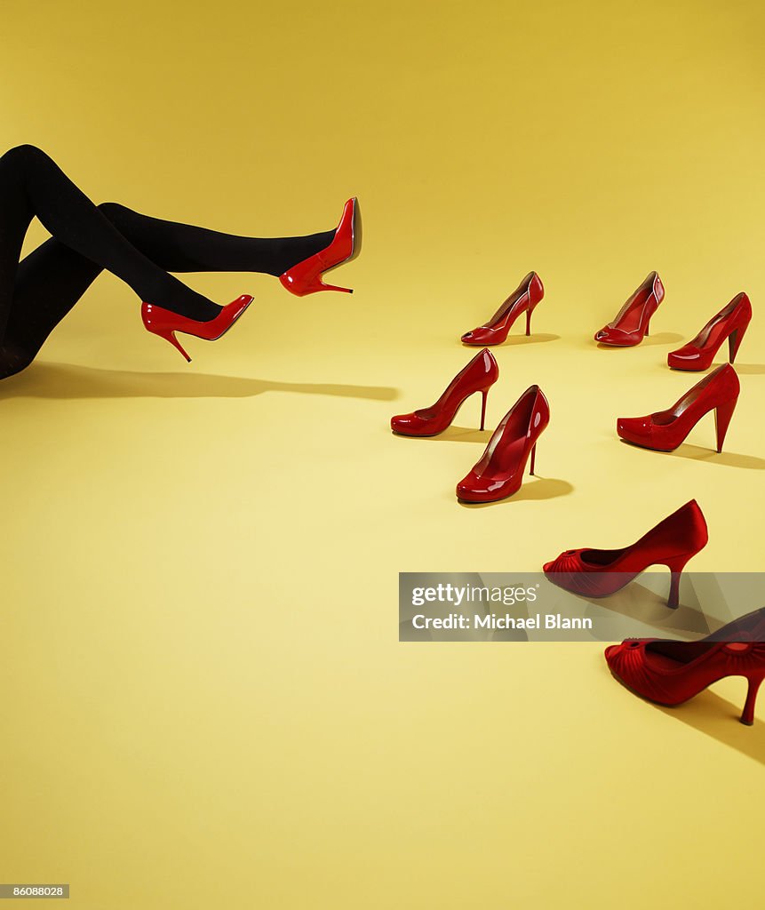 Woman trying on red shoes