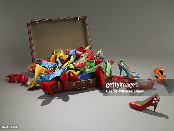 shoes overflow from suitcase - high heel stock-fotos und bilder