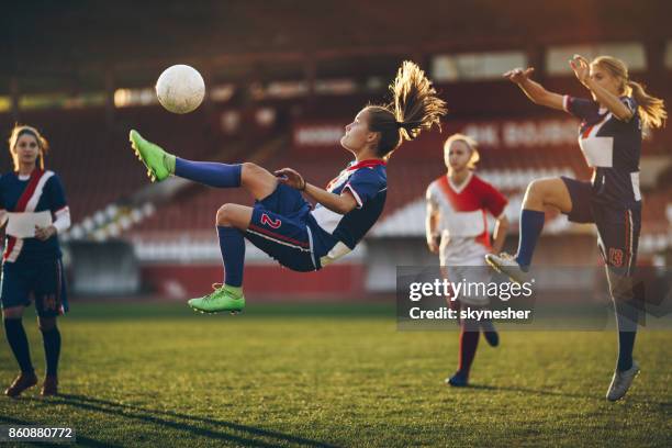 determined bicycle kick on a soccer match! - girls football stock pictures, royalty-free photos & images
