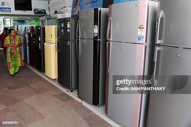 Indian prospective buyers inspect a refrigerator at Sales India on the eve of Earth Day in Ahmedabad on April 21, 2009. Earth Day on April 22 was...