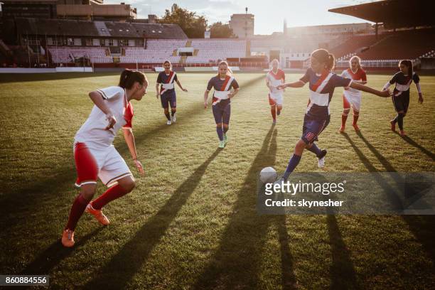 soccer striker kicking the ball during a match on a stadium. - football striker stock pictures, royalty-free photos & images