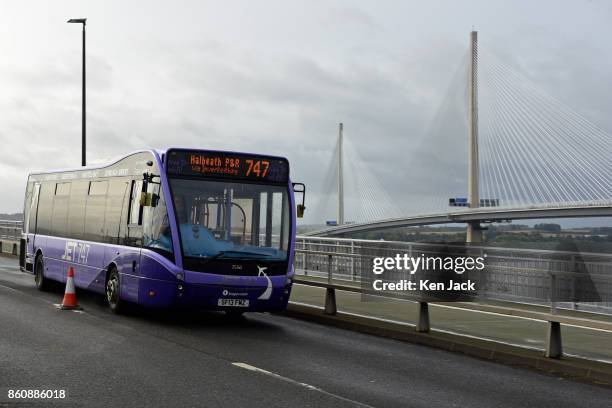Bus crosses the old Forth Road Bridge as a phased re-opening to some scheduled bus services begins, with the new Queensferry Crossing in the...