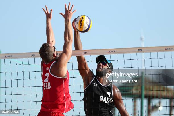 Cesar Do Nascimento Junior Julio of Qatar in action with Ahmed Tijan of Qatar during the match against Lazar Kolaric and Djordje Klasnic of Serbia on...