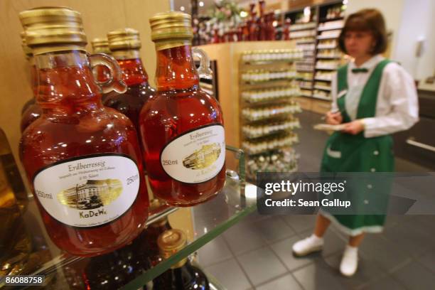 An employee checks inventory next to a shelf of strawberry vinegar at the KaDeWe luxury department store on April 21, 2009 in Berlin, Germany. German...