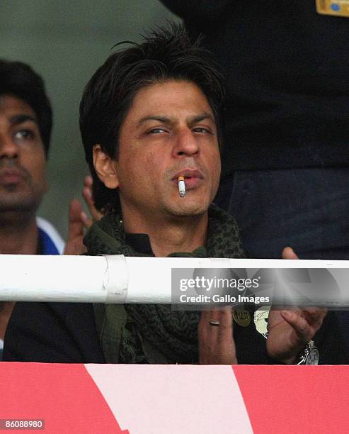 Bollywood legend Shah Rukh Khan has a cigarette during the IPL T20 match between Kings XI Punjab v Kolkata Knight Riders at Sahara Park on April 21,...