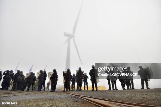 Police officers form the Gendarmerie Mobile unit face dockers who demonstrate against the labour law reform and the ecologic transition, on the...