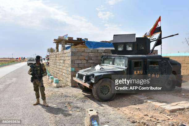 Iraqi army forces stand guard at a retaken Kurdish military position on October 13, 2017 in the northern Iraqi town of Taza Khurmatu, near Iraq's...