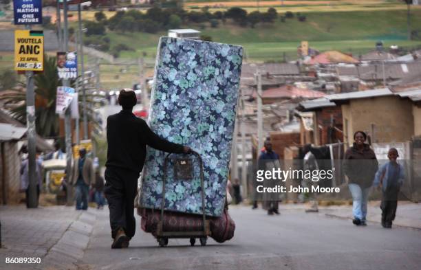 South Africans walk down a street a day ahead of national and provincial elections April 21, 2009 in Alexandra township on the outskirts of...