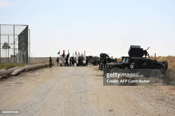 Iraqi federal police stand guard at a former Kurdish military position on October 13, 2017 in the northern Iraqi town of Taza Khurmatu, near Iraq's...