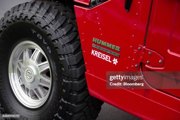 Logo sits on the bodywork of a modified electric Hummer H1 sport utility vehicle on display at the Kreisel Electric GmbH research center and battery...