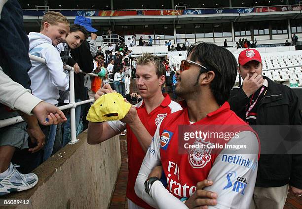 Brett Lee of Kings XI Punjab signs autographs as Sree Sreesanth looks on during the IPL T20 match between Kings XI Punjab v Kolkata Knight Riders at...