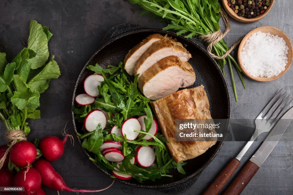 Roast pork fillet with arugula and radish salad