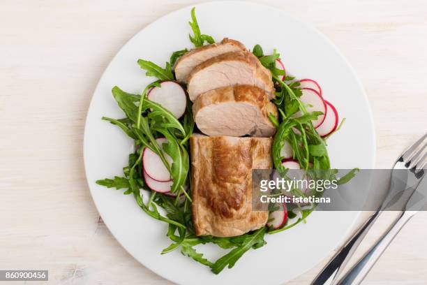 pork fillet with arugula and radish salad - main course stock pictures, royalty-free photos & images