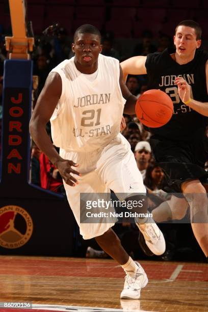 Mouphtauo Yarou of the White team dribbles against Ryan Kelly of the Black team during the 2009 Jordan Brand All-American Classic at Madison Square...