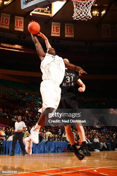 Mouphtauo Yarou of the White team dunks against Ryan Kelly of the Black team during the 2009 Jordan Brand All-American Classic at Madison Square...