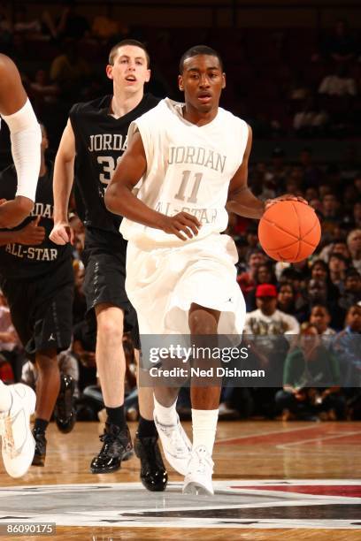 John Wall of the White team dribbles against Ryan Kelly of the Black team during the 2009 Jordan Brand All-American Classic at Madison Square Garden...