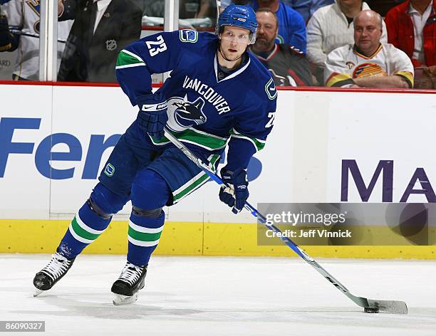 Alexander Edler of the Vancouver Canucks skates up ice with the puck during Game Two of the Western Conference Quarterfinal Round of the 2009 Stanley...