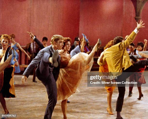 Cast members dance in a gymnasium set in a scene from 'West Side Story' , 1961.