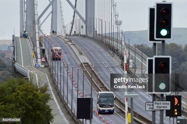 Buses cross the old Forth Road Bridge as a phased re-opening to some scheduled bus services begins, on October 13, 2017 in South Queensferry,...