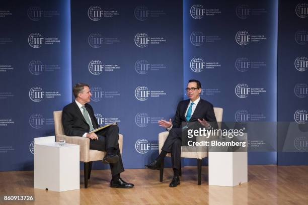 Steven Mnuchin, U.S. Treasury secretary, right, speaks while Tim Adams, president and chief executive officer of the Institute of International...
