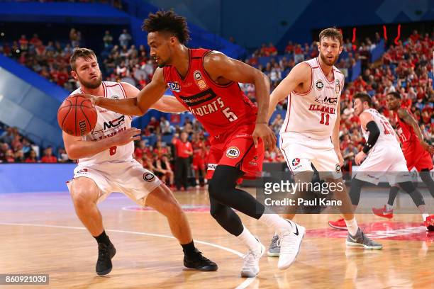 Jean-Pierre Tokoto of the Wildcats controls the ball against Mitchell Norton of the Hawks during the round two NBL match between the Perth Wildcats...
