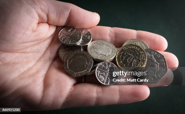 In this photo illustration old £1 coins are seen among handful of other change on October 13, 2017 in Bristol, England. The deadline to use the old...