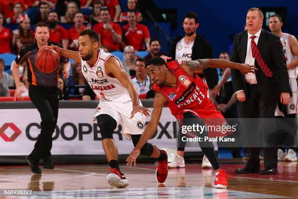 Demitrius Conger of the Hawks controls the ball against Bryce Cotton of the Wildcats during the round two NBL match between the Perth Wildcats and...