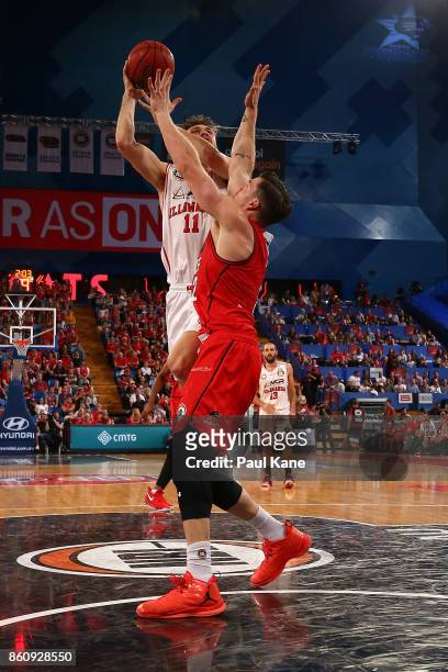Nicholas Kay of the Hawks puts a shot up against Lucas Walker of the Wildcats during the round two NBL match between the Perth Wildcats and the...