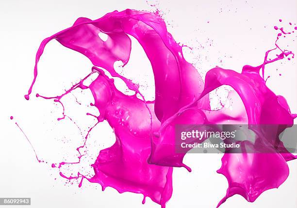 vivid pink splash water in the air - paint splash stockfoto's en -beelden