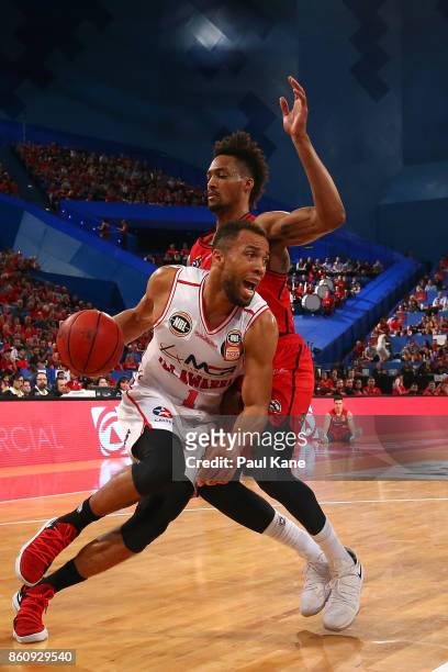 Demitrius Conger of the Hawks drives to the basket against Jean-Pierre Tokoto of the Wildcats during the round two NBL match between the Perth...