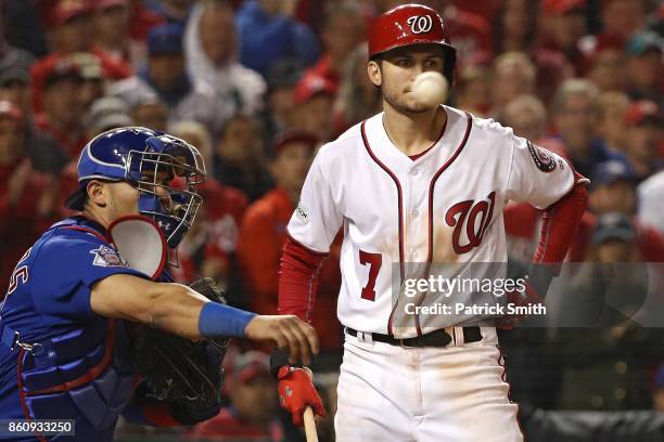 Catcher Willson Contreras of the Chicago Cubs throws the ball in front of batter Trea Turner of the Washington Nationals to pick-off Jose Lobaton of...