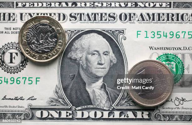 In this photo illustration, a £1 coin is seen a US dollar bill and 1 euro coin on October 13, 2017 in Bath, England. Currency experts have warned...