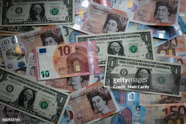 In this photo illustration, the new £10 note is seen alongside euro notes and US dollar bills on October 13, 2017 in Bath, England. Currency experts...