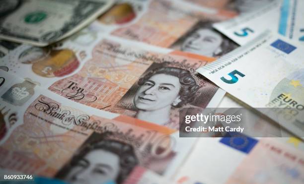 In this photo illustration, the new £10 note is seen alongside euro notes and US dollar bills on October 13, 2017 in Bath, England. Currency experts...