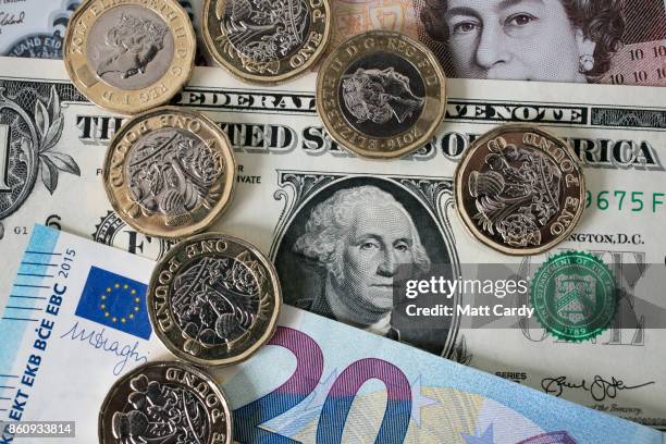 In this photo illustration, £1 coins are seen with the new £10 note alongside euro notes and US dollar bills on October 13, 2017 in Bath, England....