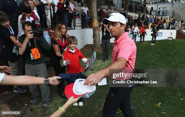 Francesco Molinari of Italy drops a ball in to a fan's hat during day two of the Italian Open at Golf Club Milano - Parco Reale di Monza on October...