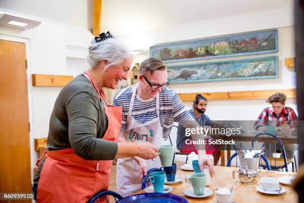 volunteering in the farm cafe - man laughing europe stock pictures, royalty-free photos & images