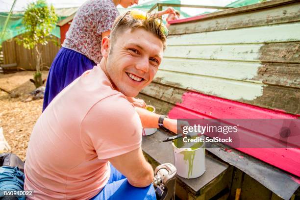 painting the chicken coop - amputee stock pictures, royalty-free photos & images