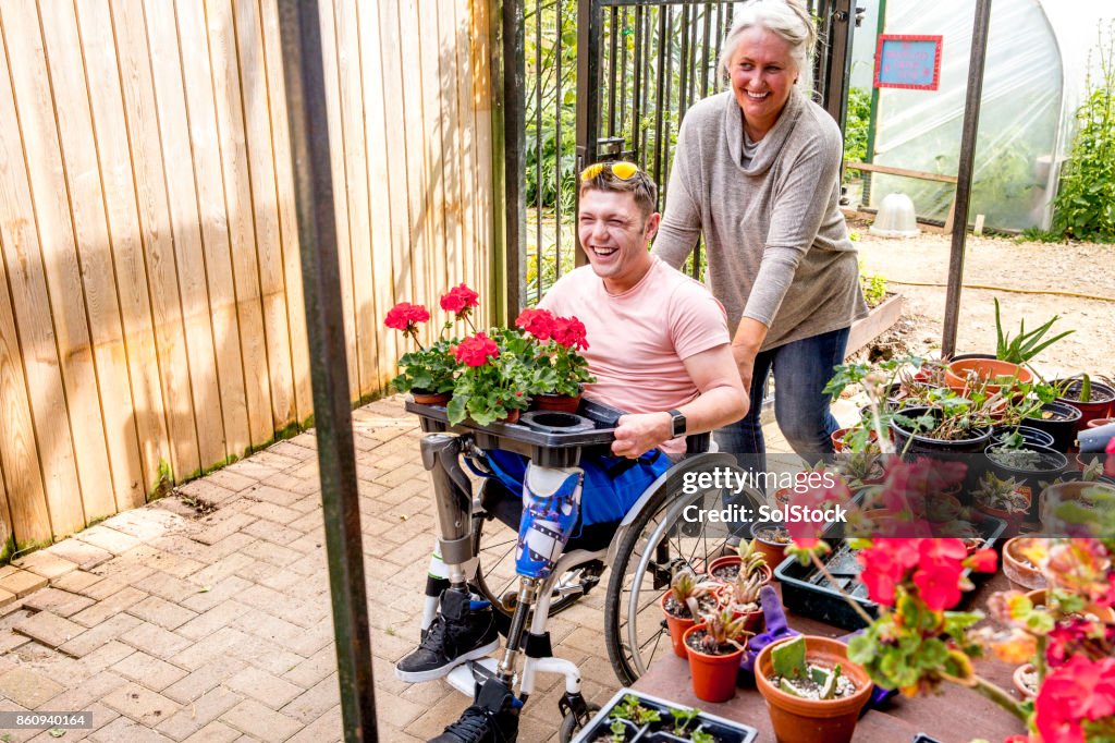 Man Carrying Flowerpots