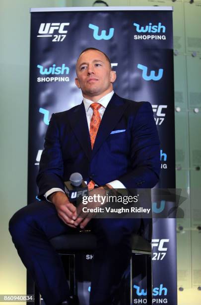 Georges St-Pierre looks on during the UFC 217 press conference with Michael Bisping and Dana White at the Hockey Hall of Fame on October 13, 2017 in...