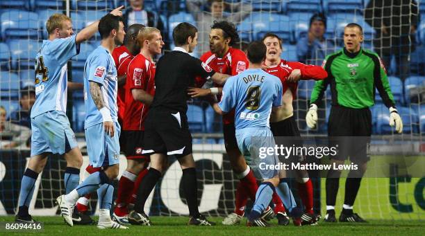 Barnsley players argue with referee Stephen Cook, after a penalty decision during the Coca-Cola Championship match between Coventry City and Barnsley...